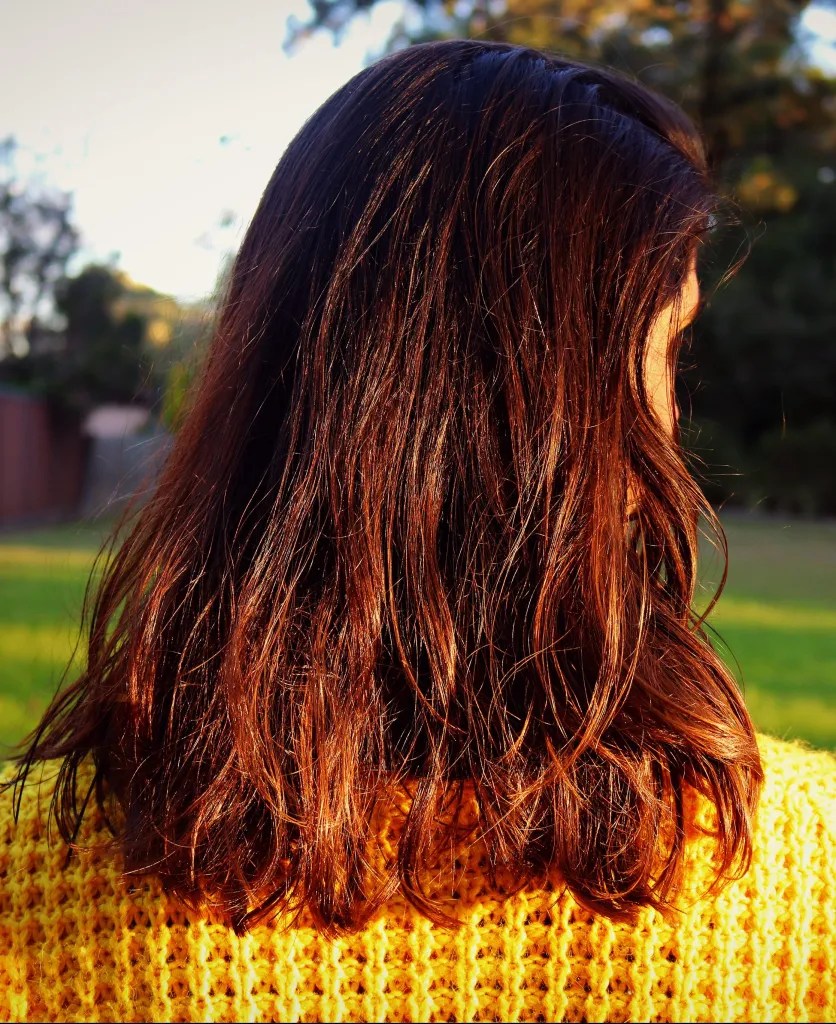 applying hair lightener for highlights