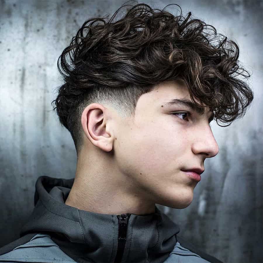 Man with curly top and low fade hairstyle