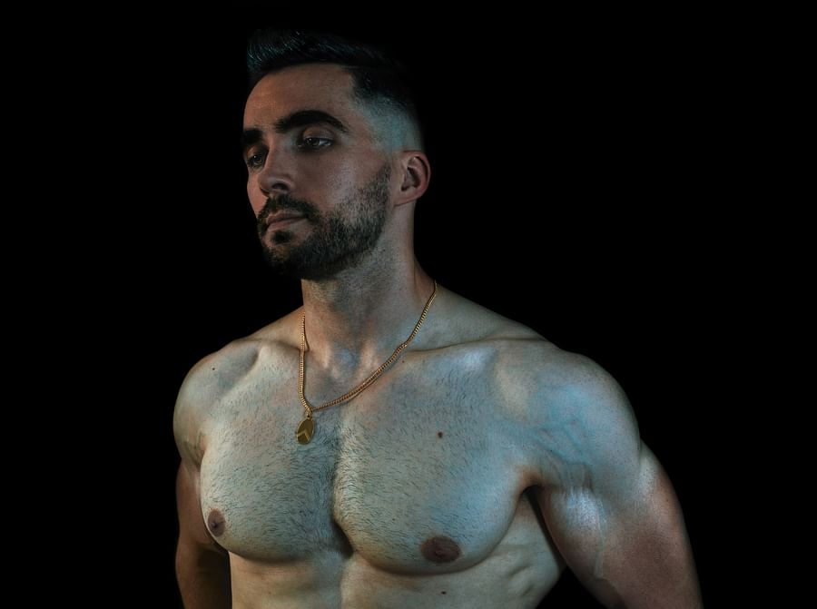 Man with long, thick hair looking into a mirror